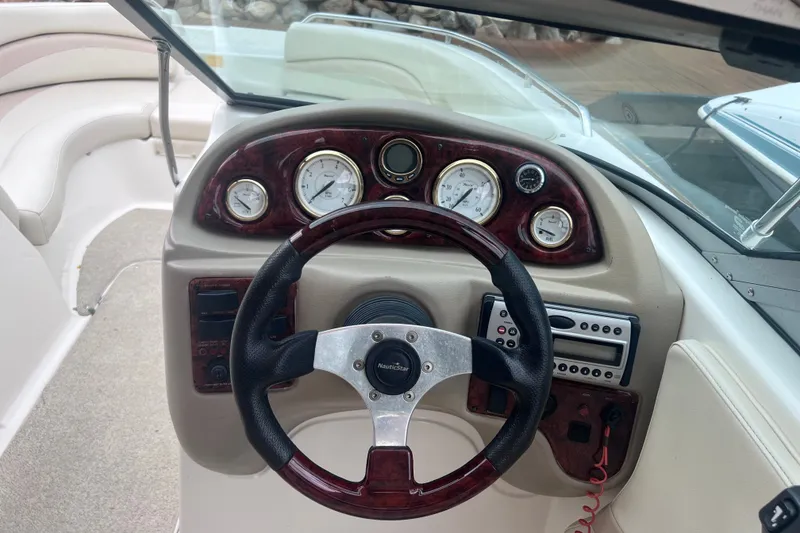 Slide: The Image of Steering console of 2007 NauticStar 230 Sport Deck boat with gauges and controls. - 9