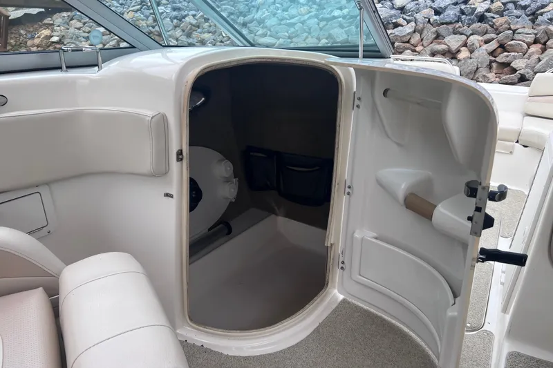 Slide: The Image of 2007 NauticStar 230 Sport Deck interior with open storage compartment and seating. - 14