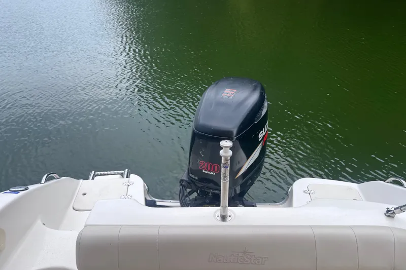 Slide: The Image of 2007 NauticStar 230 Sport Deck boat with Suzuki 200 outboard motor on calm water. - 12