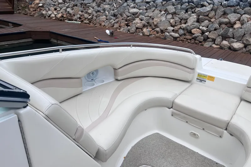 Slide: The Image of 2007 NauticStar 230 Sport Deck boat with beige seating and speaker, dockside view. - 6