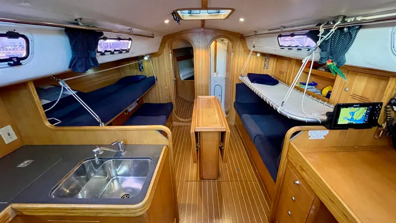 Slide: The Image of Interior of a 2000 J/120 with wood finish, kitchenette, seating area, and navigation system. - 30