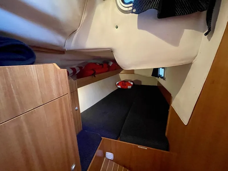 Slide: The Image of Cabin of a 2000 J/120 with wooden furnishings and sleeping area. - 28