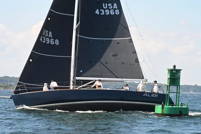 The Image of Sailing yacht J/120 from 2000, named "ALIBI," navigating near a green buoy. - 0