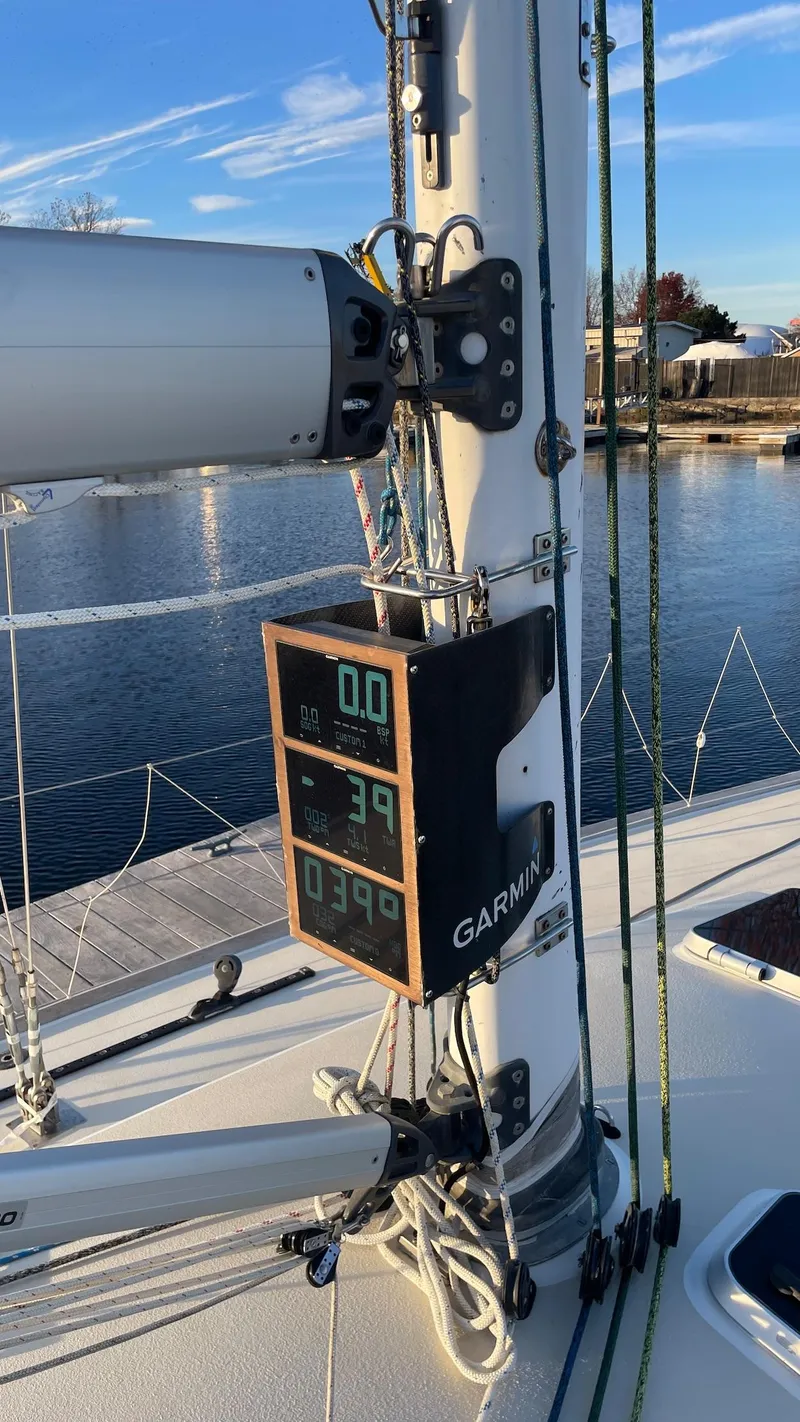 Slide: The Image of A 2000 J/120 sailboat with a Garmin instrument on the mast displaying various data. - 11