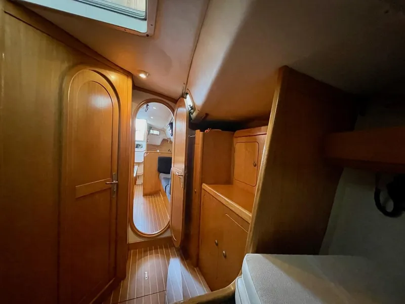 Slide: The Image of Interior of a 2000 J/120 yacht with wood paneling and a cabin door. - 25