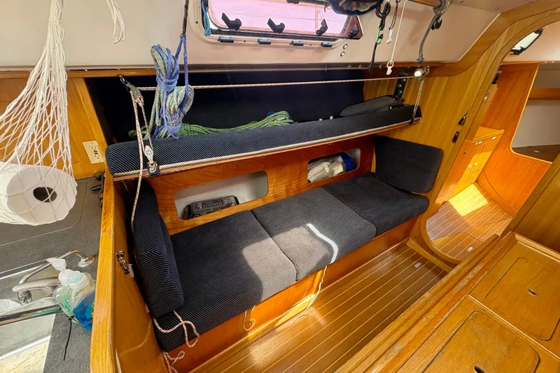 Slide: The Image of Interior of 2000 J Boats J/120 sailboat with wooden finish and cozy seating area. - 17