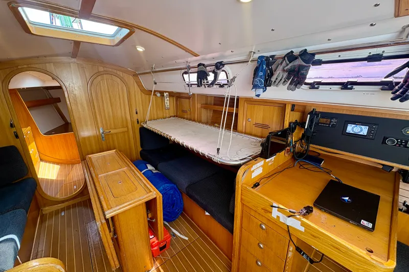 Slide: The Image of Interior of 2000 J Boats J/120 sailboat with wooden cabinetry and navigation equipment. - 15