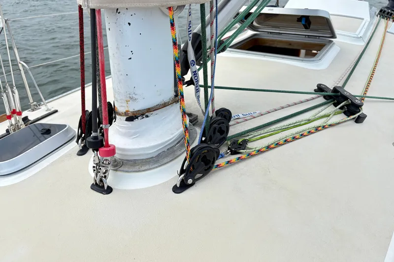 Slide: The Image of Deck rigging on a 2000 J Boats J/120 sailboat, featuring colorful ropes and pulleys. - 9