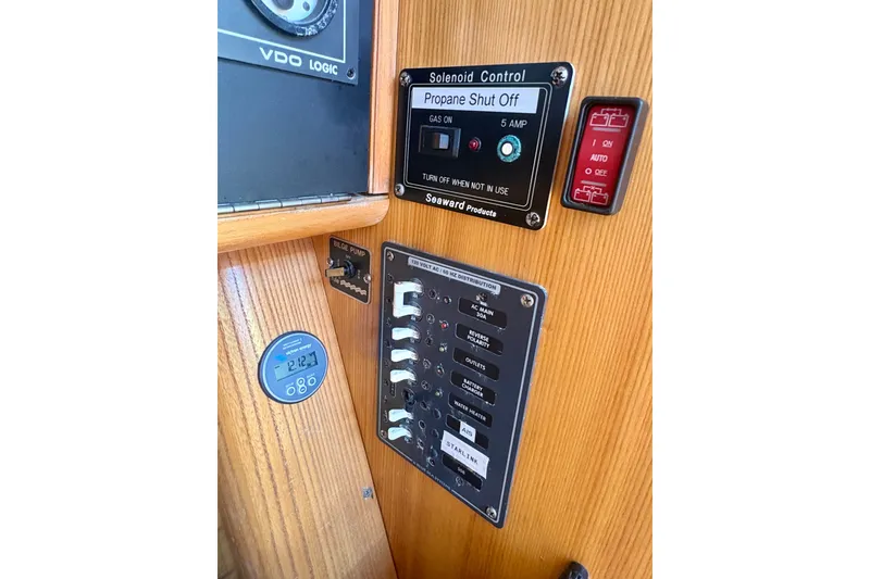 Slide: The Image of Control panel of a 2000 J Boats J/120 yacht, featuring switches and gauges. - 13