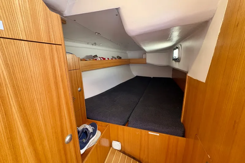 Slide: The Image of Cozy cabin interior of 2000 J Boats J/120 sailboat with wooden finish and storage. - 19