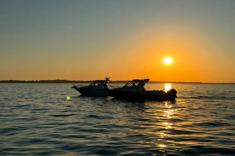 Slide: The Image of Two Extreme Boats 745 Walk Around models at sunset on calm waters, 2022. - 4