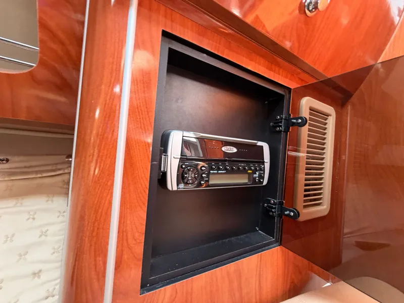 Slide: The Image of A sleek wooden cabinet compartment with a built-in radio inside. - 34