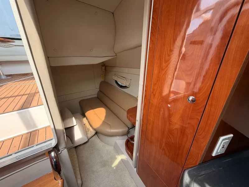 Slide: The Image of The cabin of a 2005 Doral Intrigue with a beige sofa and wooden furnishings. - 30