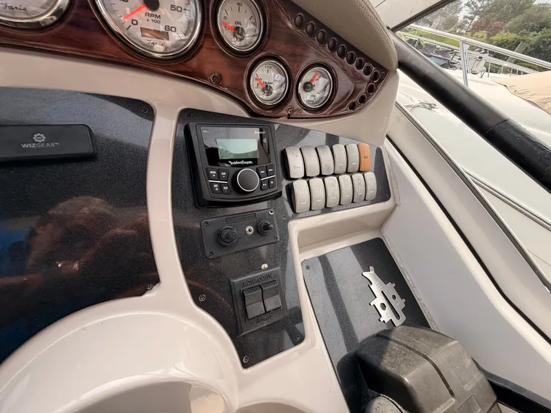 Slide: The Image of The image shows the dashboard of a 2005 Doral Intrigue boat with various gauges and switches. - 17