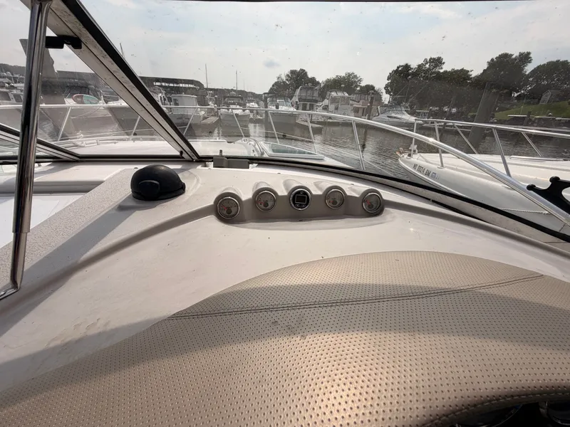 Slide: The Image of The image shows the dashboard of a 2005 Doral Intrigue boat docked in a marina. - 20