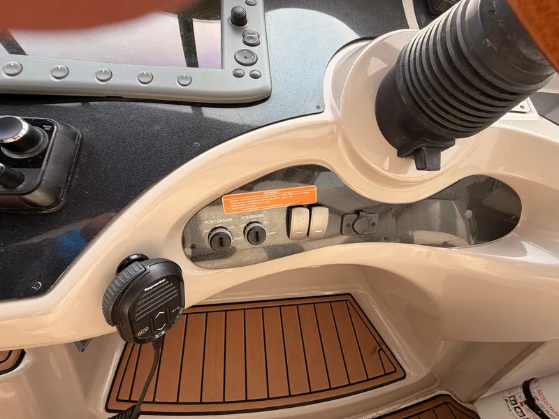 Slide: The Image of Close-up of a 2005 Doral Intrigue helm with controls and wood-patterned flooring. - 18
