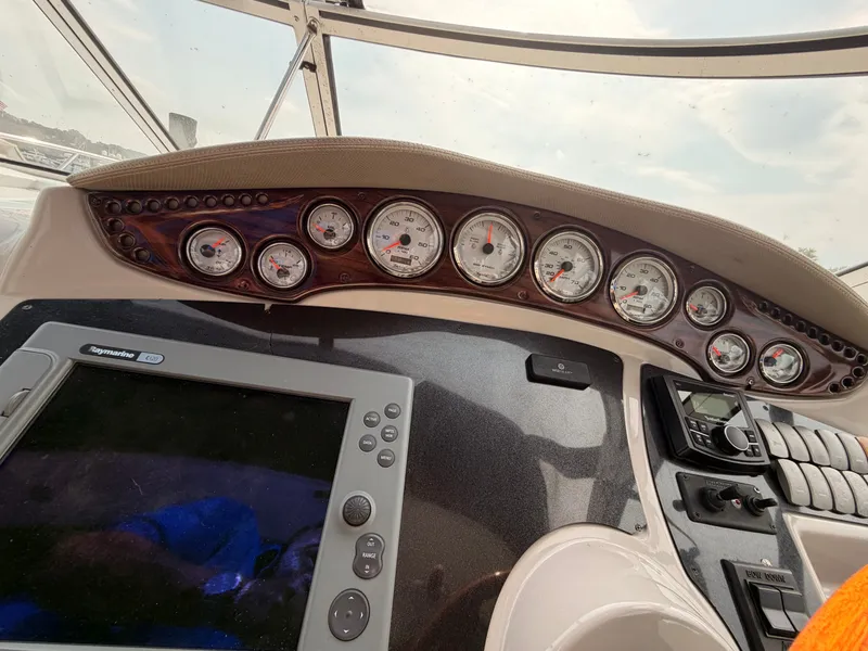 Slide: The Image of The image shows the dashboard of a 2005 Doral Intrigue boat with multiple gauges and a screen. - 19