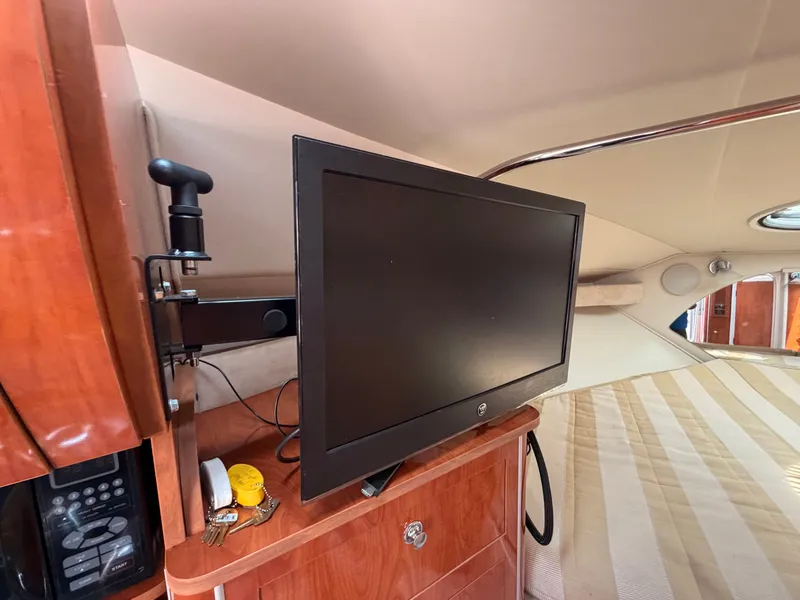 Slide: The Image of The interior of a 2005 Doral Intrigue with a flat-screen TV and wooden cabinetry. - 26