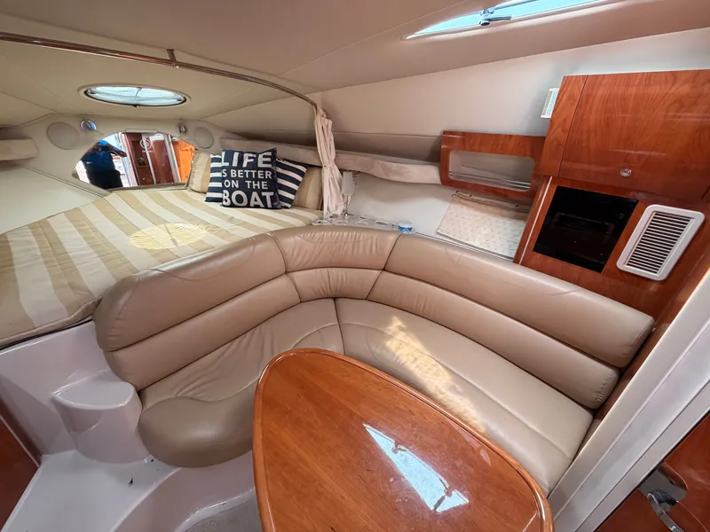 Slide: The Image of The image shows the interior of a 2005 Doral Intrigue with a beige leather couch and wooden table. - 22