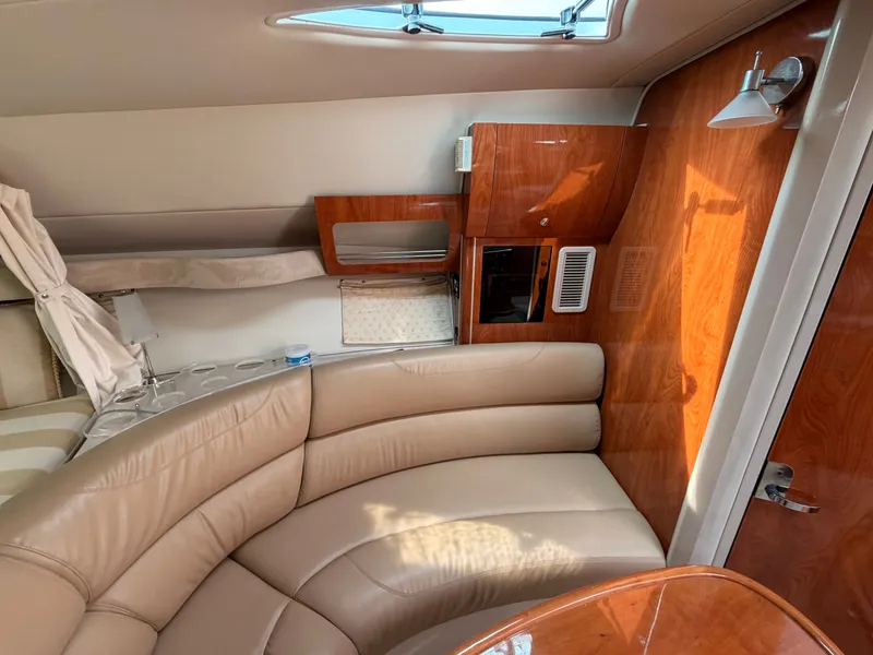 Slide: The Image of The interior cabin of a 2005 Doral Intrigue with beige leather seating and wooden walls. - 28