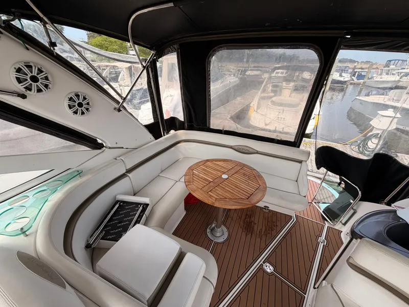 Slide: The Image of The image shows the cockpit of a 2005 Doral Intrigue with white seating and a wooden table. - 11