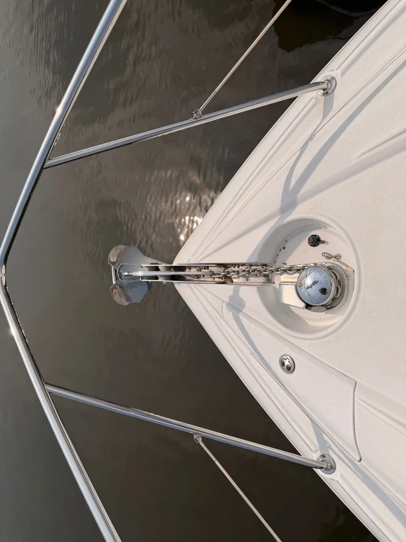 Slide: The Image of The image shows the bow of a 2005 Doral Intrigue boat with an anchor windlass. - 36