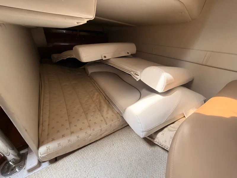 Slide: The Image of The 2005 Doral Intrigue cabin features a cushioned sleeping area with beige pillows. - 31