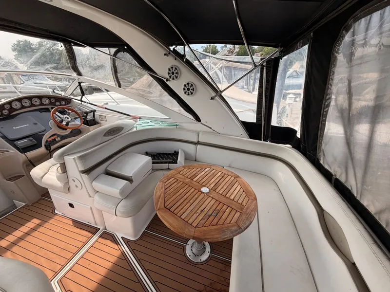 Slide: The Image of The image shows the cockpit of a 2005 Doral Intrigue with a wooden table and beige seating. - 9