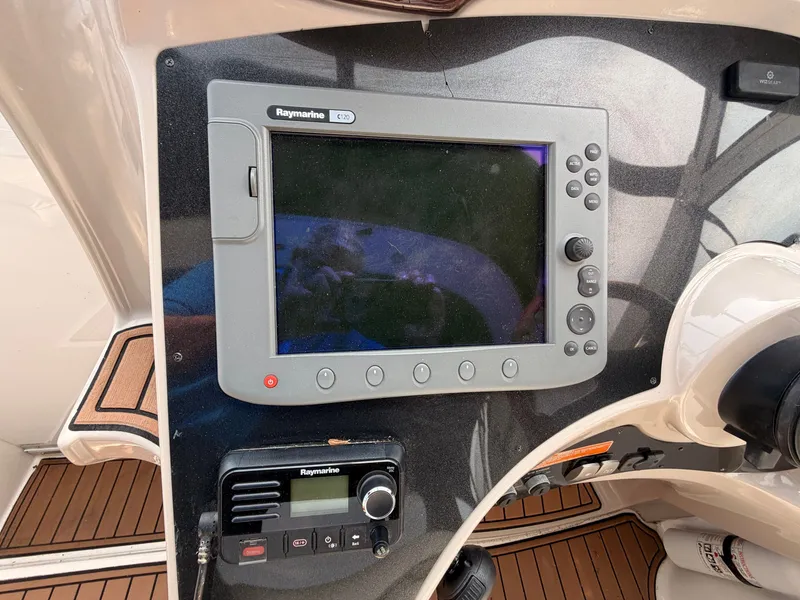 Slide: The Image of The image shows the dashboard of a 2005 Doral Intrigue with a Raymarine GPS system. - 16