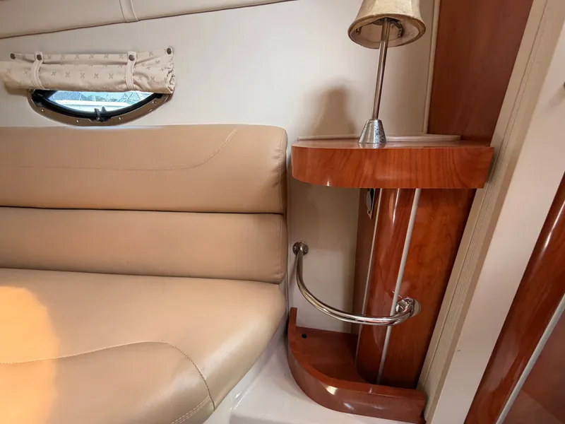 Slide: The Image of Interior of a 2005 Doral Intrigue with beige leather sofa and wooden table with lamp. - 32