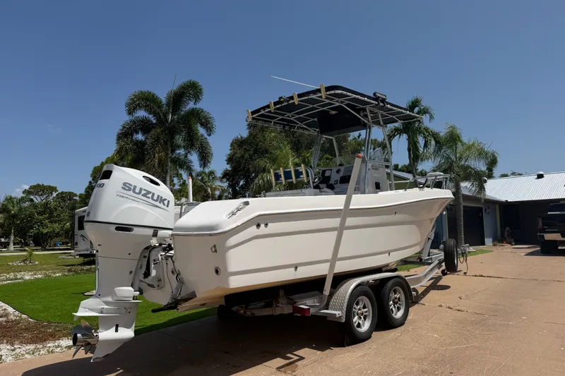 Slide: The Image of 2003 Robalo R230 Center Console boat on trailer with Suzuki outboard motor. - 2