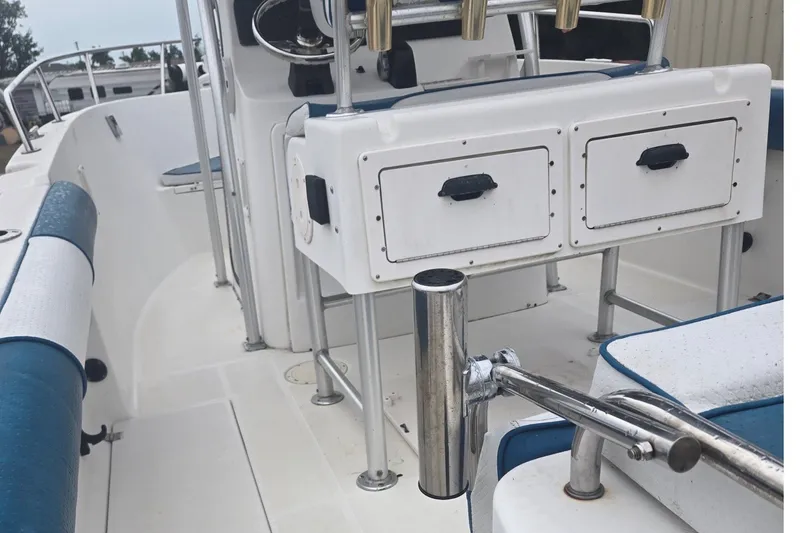 Slide: The Image of 2003 Robalo R230 Center Console boat interior with storage compartments and seating. - 6