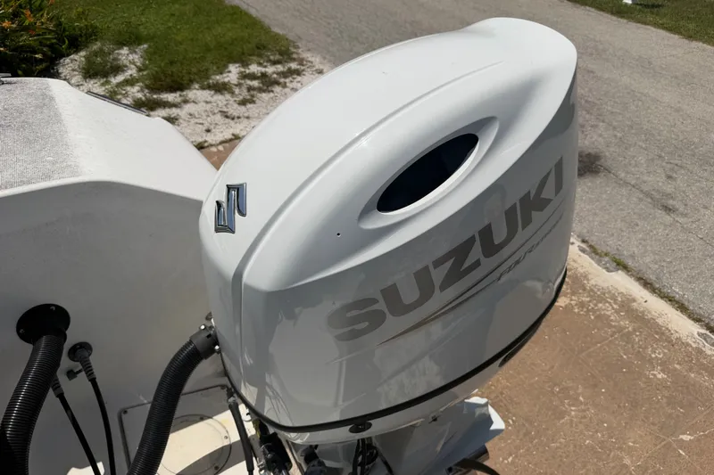 Slide: The Image of Suzuki outboard motor on a 2003 Robalo R230 Center Console boat. - 5