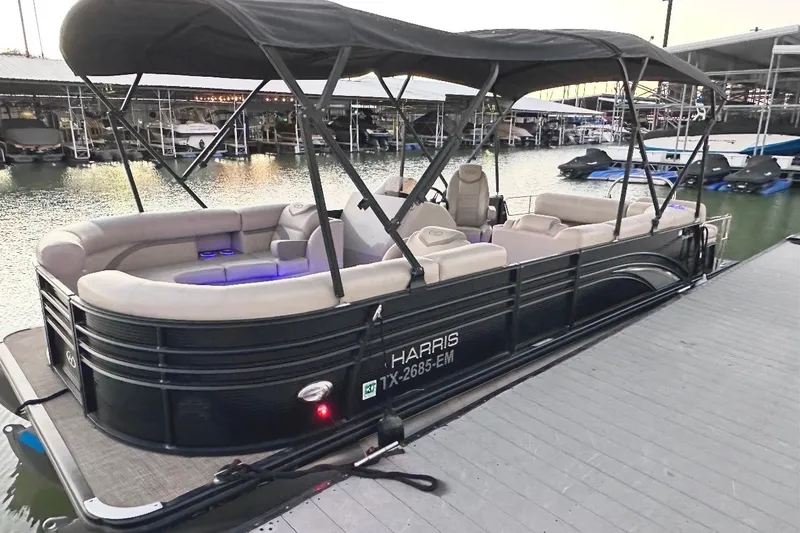 The Image of 2019 Harris Sunliner 240 pontoon boat docked at marina with canopy and seating. - 0
