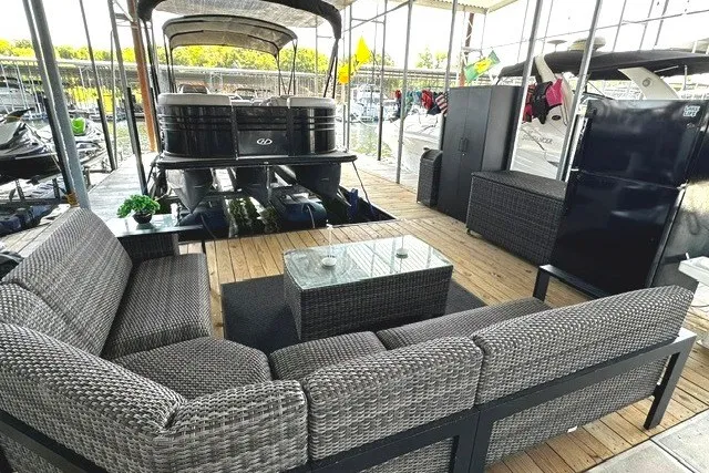 Slide: The Image of Outdoor seating area with wicker furniture beside a 2019 Harris Sunliner 240 pontoon boat. - 36