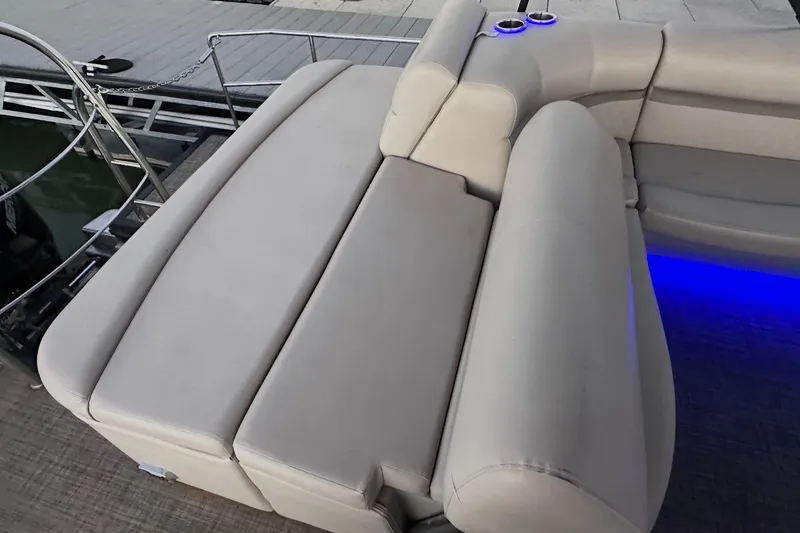 Slide: The Image of Luxurious seating on 2019 Harris Sunliner 240 pontoon boat with ambient blue lighting. - 35