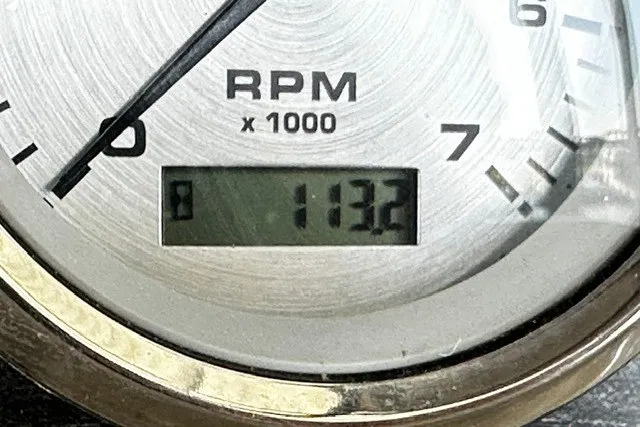Slide: The Image of Close-up of a Harris Sunliner 240 tachometer displaying 1132 RPM. - 19