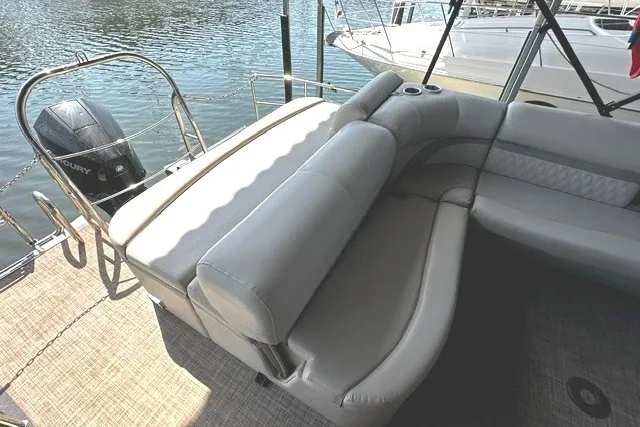 Slide: The Image of 2019 Harris Sunliner 240 boat with comfortable seating and Mercury outboard motor on a sunny day. - 12