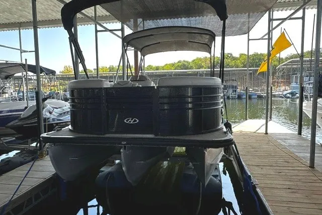 Slide: The Image of 2019 Harris Sunliner 240 pontoon boat docked in a marina under a canopy. - 4