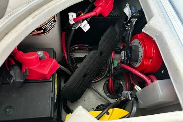 Slide: The Image of Battery compartment of a 2019 Harris Sunliner 240 boat with wiring and connections. - 29