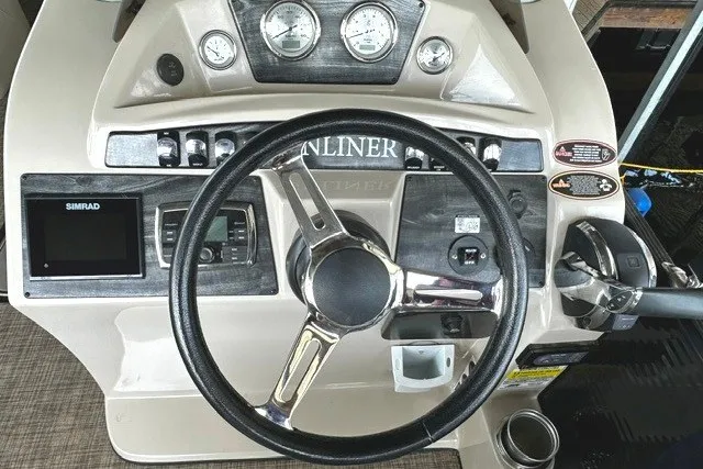 Slide: The Image of Steering console of 2019 Harris Sunliner 240 boat with gauges and controls. - 17