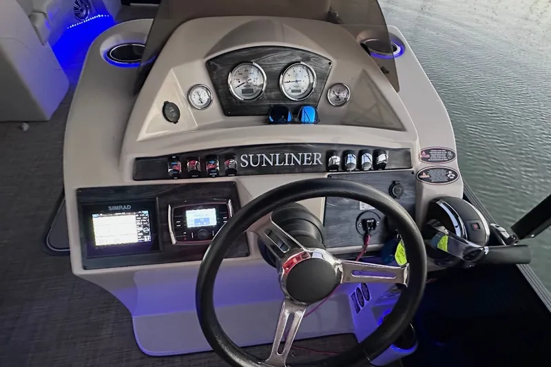 Slide: The Image of 2019 Harris Sunliner 240 boat dashboard with steering wheel and control panel. - 33