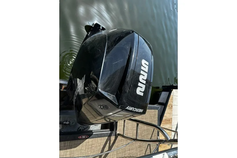 Slide: The Image of Mercury outboard motor on 2019 Harris Sunliner 240 pontoon boat by the water. - 26