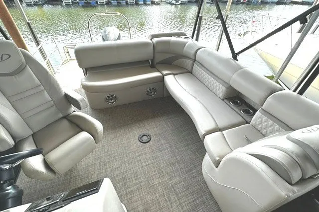 Slide: The Image of 2019 Harris Sunliner 240 boat interior with plush seating and lake view. - 10