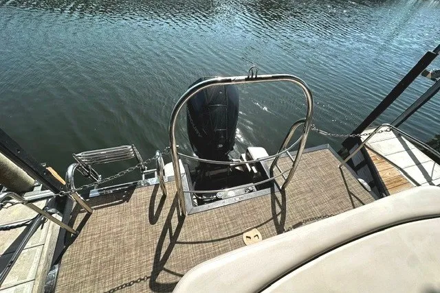 Slide: The Image of 2019 Harris Sunliner 240 boat with outboard motor on a calm lake. - 14