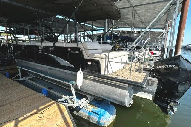 Slide: The Image of 2019 Harris Sunliner 240 pontoon boat docked with Mercury outboard motor. - 8
