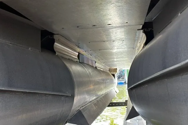 Slide: The Image of Underneath view of a 2019 Harris Sunliner 240 pontoon boat, showcasing its dual pontoons. - 27