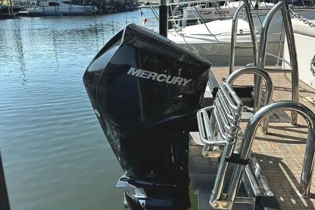 Slide: The Image of 2019 Harris Sunliner 240 with Mercury outboard motor docked by the water. - 7