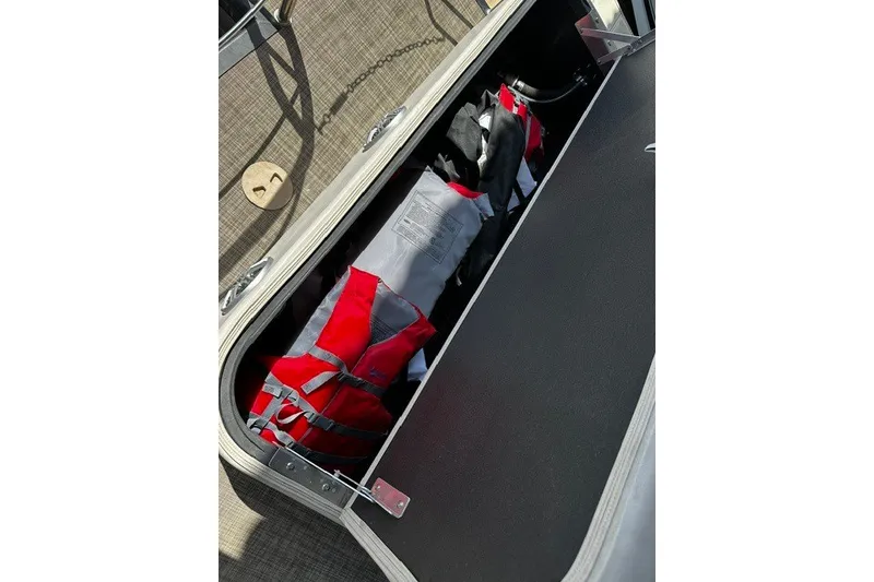 Slide: The Image of Storage compartment on 2019 Harris Sunliner 240 boat with life jackets inside. - 30