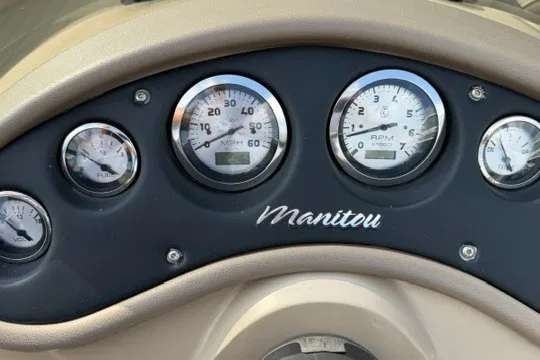 Slide: The Image of Dashboard of 2017 Manitou 22 Oasis Standard with speedometer and RPM gauges. - 15